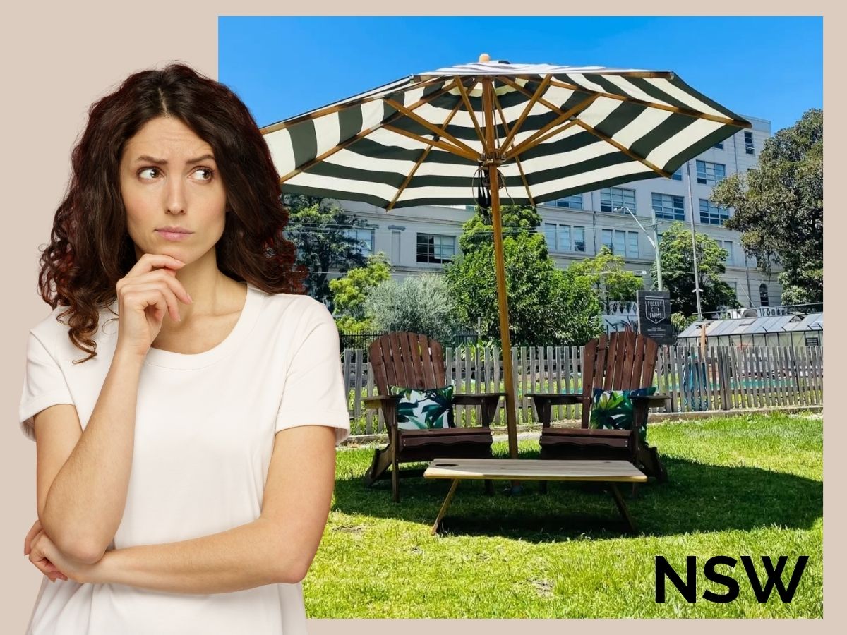 A woman on the left has a pensive expression. The right side of the umbrella has a black and white octagonal umbrella with a timber pole set up with some chairs.